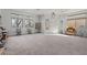 Bright and spacious living room with large windows, neutral walls and carpeted floors at 1077 Las Palmas Entrada Ave, Henderson, NV 89012
