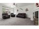 Spacious living room featuring comfortable seating, fireplace, and bright natural light at 1077 Las Palmas Entrada Ave, Henderson, NV 89012