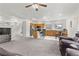 Open-concept living room with a kitchen featuring modern stainless steel appliances and a breakfast bar at 1077 Las Palmas Entrada Ave, Henderson, NV 89012