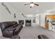 Open-concept living room featuring a fireplace, seamlessly connecting to the kitchen at 1077 Las Palmas Entrada Ave, Henderson, NV 89012