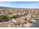 Wide neighborhood shot showcasing the home's location within a vibrant community with palm trees and mountain views at 1077 Las Palmas Entrada Ave, Henderson, NV 89012