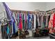 Walk-in closet with organized hanging clothes and shoe racks at 1077 Las Palmas Entrada Ave, Henderson, NV 89012