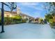 View of the backyard with a concrete patio and an in-ground pool, and a basketball hoop above the patio at 10813 Oak Shadow Ave, Las Vegas, NV 89144