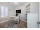 Bright office features gray plank floors, white walls and millwork, floating shelves and large window with shutter at 10813 Oak Shadow Ave, Las Vegas, NV 89144