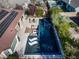 Striking aerial shot of modern pool with sleek tile design, lounge chairs, and fire pit area surrounded by desert landscaping at 10813 Oak Shadow Ave, Las Vegas, NV 89144