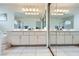 Primary bathroom showing double sinks with a large mirror and tiled floors at 10900 Calcedonian St, Las Vegas, NV 89141
