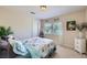 Bedroom showcasing a light color palette, bright window, and patterned bedspread at 10900 Calcedonian St, Las Vegas, NV 89141