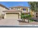 Inviting two-story home with a terra cotta tile roof, desert landscaping, and a two-car garage at 10900 Calcedonian St, Las Vegas, NV 89141