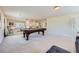 Spacious game room features a pool table, neutral carpet, and ample natural light at 10900 Calcedonian St, Las Vegas, NV 89141