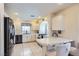 Bright kitchen with white cabinets, tiled countertops, and stainless steel appliances at 10900 Calcedonian St, Las Vegas, NV 89141