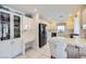 Clean kitchen featuring white cabinets, tiled countertops, stainless steel appliances, and an integrated desk at 10900 Calcedonian St, Las Vegas, NV 89141