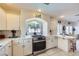 A kitchen features white cabinets, tiled countertops, and stainless steel appliances at 10900 Calcedonian St, Las Vegas, NV 89141