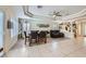 Open-concept dining and living space featuring modern lighting, tile floors, and staircase to upper level at 10900 Calcedonian St, Las Vegas, NV 89141