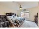 The main bedroom features a ceiling fan, large window, and an ensuite bath at 10900 Calcedonian St, Las Vegas, NV 89141