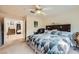 Carpeted main bedroom featuring a king bed, ceiling fan, and an ensuite at 10900 Calcedonian St, Las Vegas, NV 89141