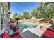 Lush backyard with a beautiful pool, relaxing lounge chairs, and tropical landscaping for a serene oasis at 10900 Calcedonian St, Las Vegas, NV 89141