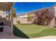 Charming backyard featuring a putting green, hammock, patio, and cozy ambiance with stylish string lights at 11484 Roncat Ct, Las Vegas, NV 89141