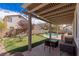 Relaxing backyard with a manicured putting green, a pool, a cozy patio, and shaded seating areas at 11484 Roncat Ct, Las Vegas, NV 89141