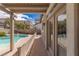 View of the inviting pool from the covered patio featuring a safety fence at 11484 Roncat Ct, Las Vegas, NV 89141