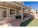 Cozy covered patio with modern outdoor furniture and artificial turf at 11484 Roncat Ct, Las Vegas, NV 89141