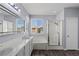 Bright bathroom featuring double sinks, large mirror, separate shower and soaking tub at 11484 Roncat Ct, Las Vegas, NV 89141