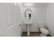 Bright half-bath with pedestal sink, toilet, and tile flooring at 11484 Roncat Ct, Las Vegas, NV 89141