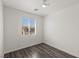 Simple bedroom with wood floors and a window offering plenty of natural light at 11484 Roncat Ct, Las Vegas, NV 89141