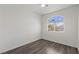 Bright bedroom features a high arched window and wood flooring at 11484 Roncat Ct, Las Vegas, NV 89141