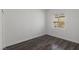 Bright, empty bedroom with hardwood floors and a window at 11484 Roncat Ct, Las Vegas, NV 89141