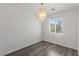 This simple bedroom features wood floors, a chandelier, and a window with blinds at 11484 Roncat Ct, Las Vegas, NV 89141