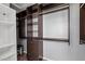 Well-organized walk-in closet featuring dark wood organizers with drawers and shelves at 11484 Roncat Ct, Las Vegas, NV 89141