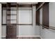 Walk-in closet featuring wood-like floors and custom dark-stained organizers at 11484 Roncat Ct, Las Vegas, NV 89141