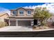 Charming two-story home featuring a three-car garage and landscaped front yard at 11484 Roncat Ct, Las Vegas, NV 89141