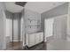 Hallway view featuring modern shelving, dark wood floors, and neutral color palette at 11484 Roncat Ct, Las Vegas, NV 89141