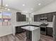 Modern kitchen with marble countertops, an island, and dark wood cabinets at 11484 Roncat Ct, Las Vegas, NV 89141