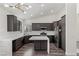 Stylish kitchen featuring sleek, dark cabinetry and white countertops, plus stainless appliances at 11484 Roncat Ct, Las Vegas, NV 89141