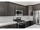 Close up of the modern kitchen featuring stainless steel appliances and white countertops at 11484 Roncat Ct, Las Vegas, NV 89141