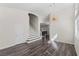 Bright living room featuring high ceilings, hardwood floors, and a staircase with white risers at 11484 Roncat Ct, Las Vegas, NV 89141