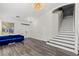 Spacious living room with hardwood floors, a blue couch, and a staircase with white risers at 11484 Roncat Ct, Las Vegas, NV 89141