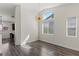 Bright living room featuring hardwood floors, a modern chandelier, and lots of natural light at 11484 Roncat Ct, Las Vegas, NV 89141