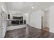 Open-concept living area with hardwood floors leading to the kitchen with dark cabinets at 11484 Roncat Ct, Las Vegas, NV 89141