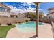 Lush backyard featuring a pristine pool, patio, decorative string lights, and privacy fencing for outdoor enjoyment at 11484 Roncat Ct, Las Vegas, NV 89141