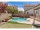 Inviting backyard with a sparkling pool, spa, a putting green, and cozy hammock for ultimate relaxation at 11484 Roncat Ct, Las Vegas, NV 89141