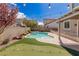 Captivating backyard oasis featuring a pool, putting green, patio, and lush landscape for outdoor relaxation at 11484 Roncat Ct, Las Vegas, NV 89141