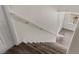 Hardwood stairs leading downstairs with a white railing and a window at the bottom at 11484 Roncat Ct, Las Vegas, NV 89141