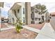 Exterior view of stucco building showcasing balconies, stairs, and desert landscaping at 1212 Bass Dr # C, Henderson, NV 89014