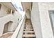 Stairway leading to upper-level units in a stucco building with shaded walkways and desert landscaping at 1212 Bass Dr # C, Henderson, NV 89014