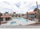 Elevated view of a pristine community pool and hot tub with surrounding lounge area near stucco building at 1212 Bass Dr # C, Henderson, NV 89014