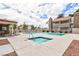 Sparkling community pool and hot tub surrounded by pavers, seating, and well-maintained landscaping at 1212 Bass Dr # C, Henderson, NV 89014
