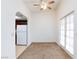 Bright dining area with tile floors leading to kitchen, carpet, a ceiling fan, and exterior access at 1212 Bass Dr # C, Henderson, NV 89014